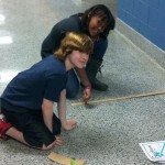 Fifth graders test 4 different objects in order to see how friction affects their speed and distance.