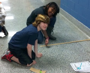 Fifth graders test 4 different objects in order to see how friction affects their speed and distance.